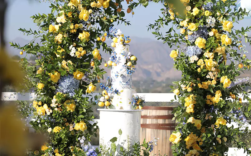 flower arch with cake in background